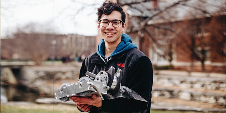 Alex Cuti in high school with a robot he built